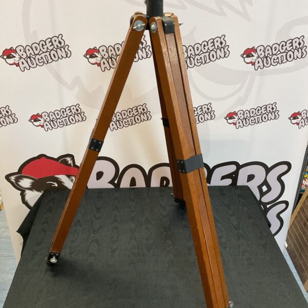 Vintage wooden tripod stand for cameras or display.