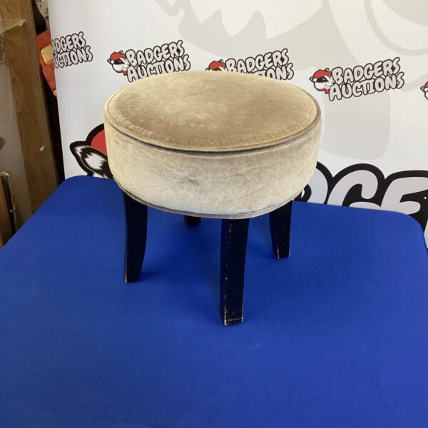 Vintage round padded stool with wooden legs.