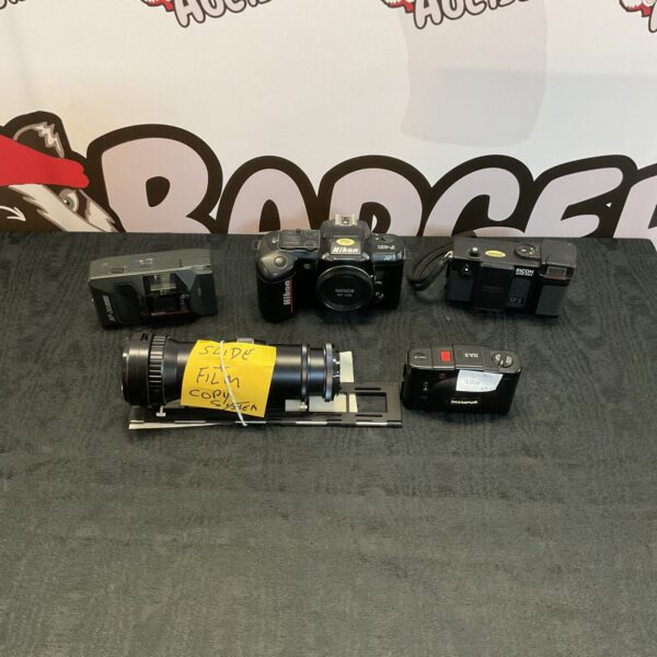 Vintage Nikon and Ricoh cameras in a photography collection.
