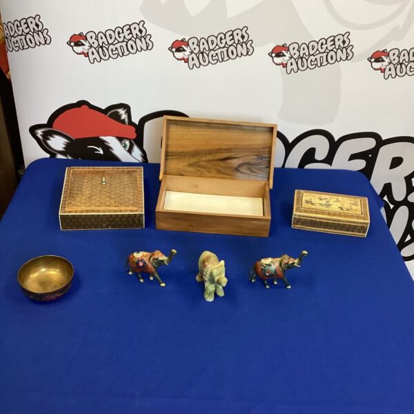 Vintage Japanese trinket boxes and elephant figurines on display.