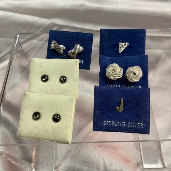 Sterling silver stud earrings featuring Nike and Adidas logos.