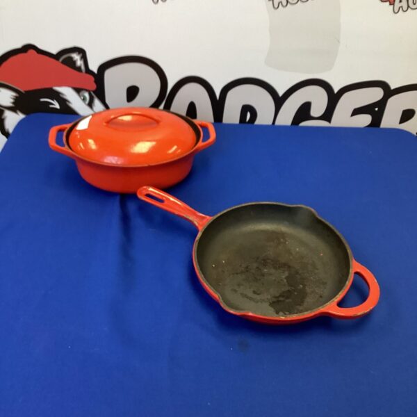 Vintage orange Colorcast casserole dish with lid and handles.