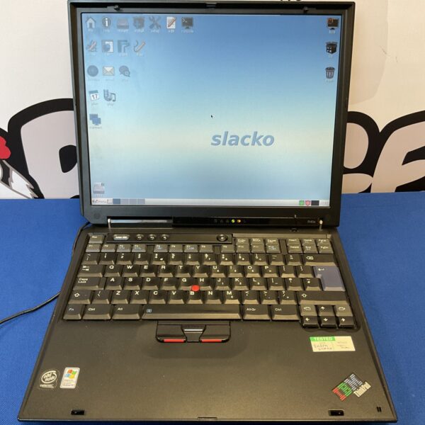 Vintage IBM Thinkpad laptop showing dual boot Windows and Linux.