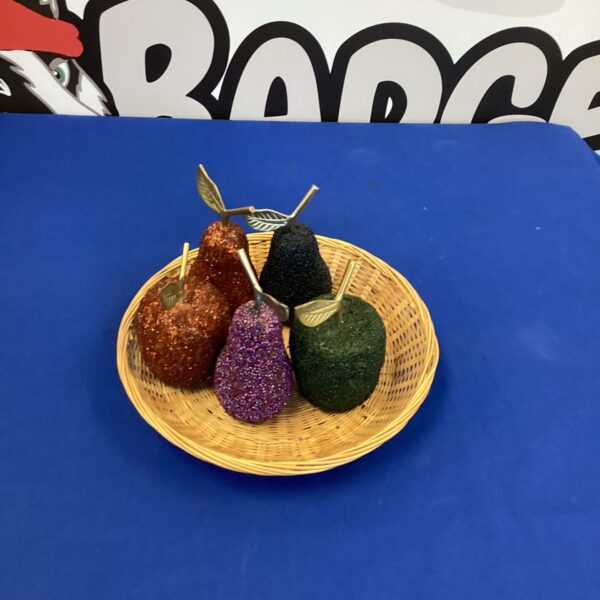 Vintage glitter fruits displayed on a woven plate.