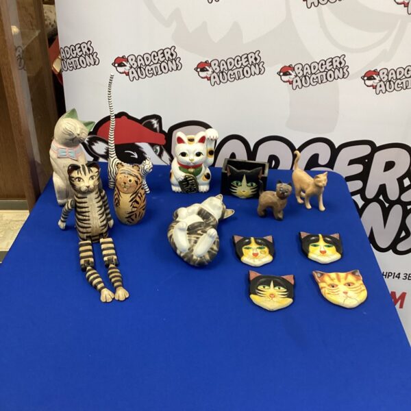 Vintage ceramic cat ornaments displayed as a collection.