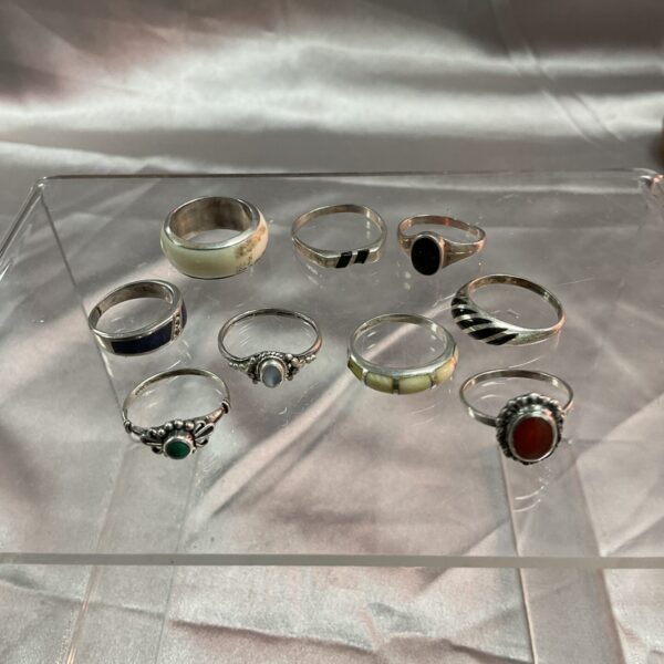 Assorted silver rings displayed on a surface, vintage jewellery lot.