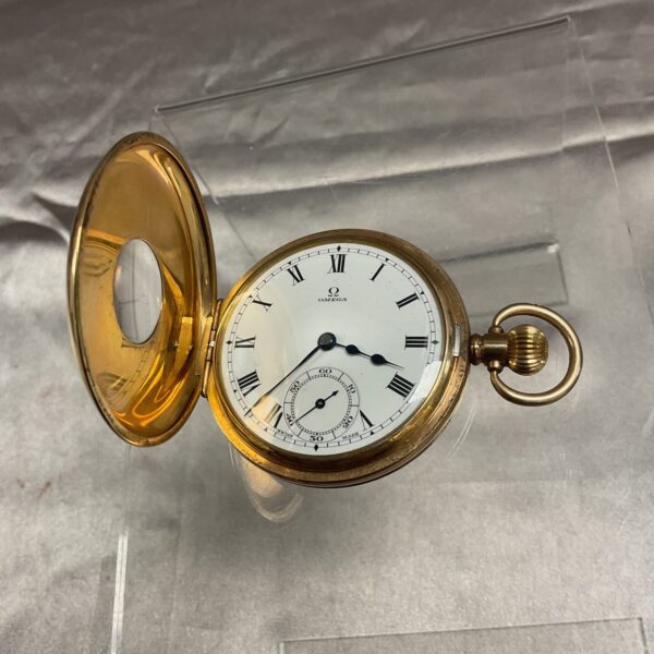 Antique Omega half-hunter pocket watch with gold case.