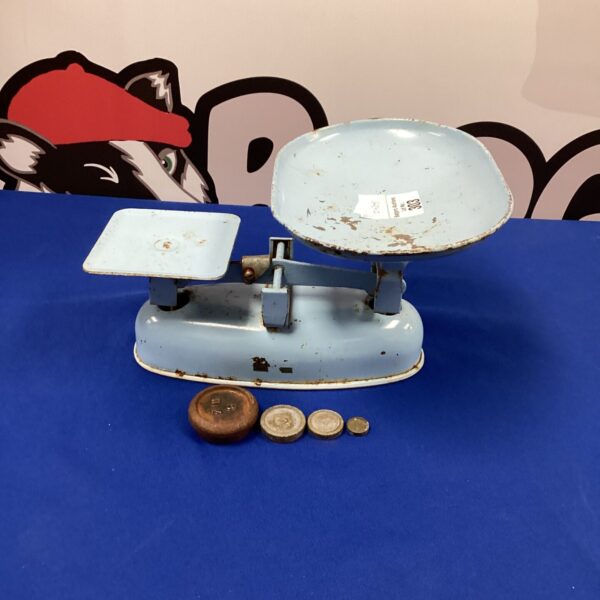 Vintage Salter kitchen scales with weights on a blue background.