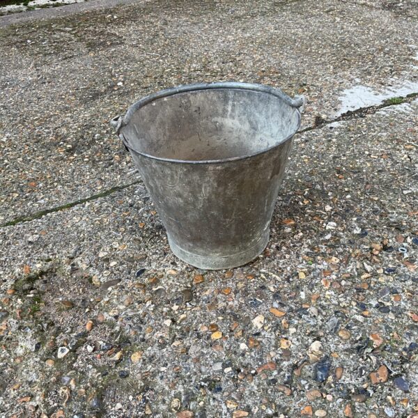 Vintage galvanised bucket with wire handle, rustic farmhouse style.