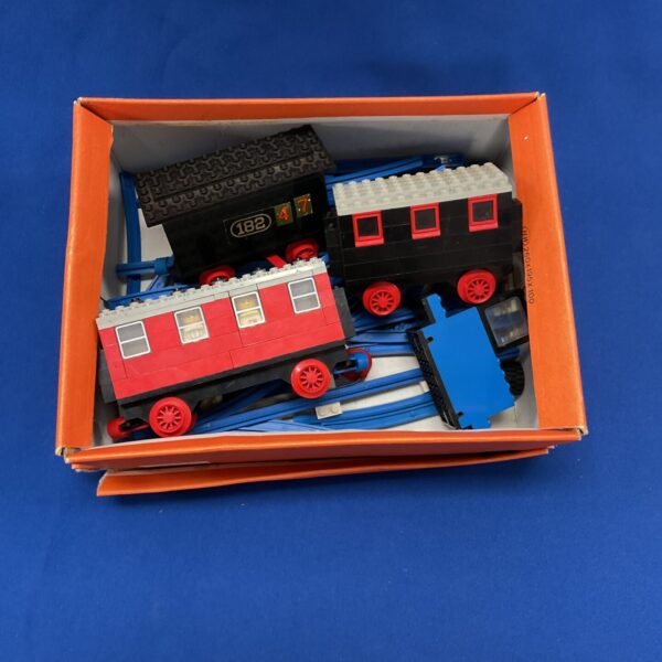 Vintage Lego train set with blue carriages and black locomotive.