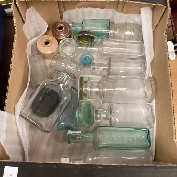 Vintage glass bottles in a collection, antique apothecary styles.