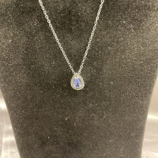Silver pendant necklace with vibrant tanzanite and diamond halo.
