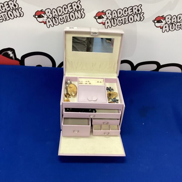 Vintage jewellery box filled with assorted jewellery and trinkets.