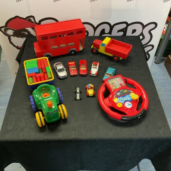 Mixed toy lot featuring a wooden bus, musical tractor, and diecast models.