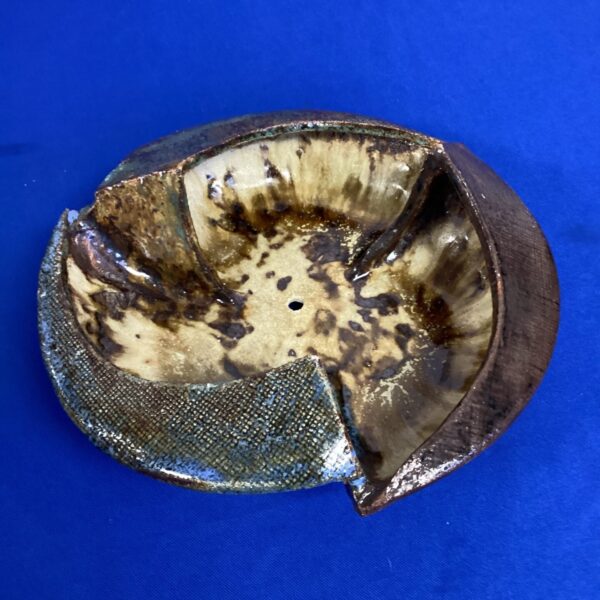 Unique studio pottery bowl with textured glaze and organic form.