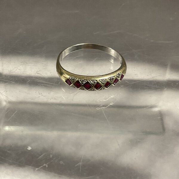 Close-up of a 9ct gold garnet and diamond ring, size R.