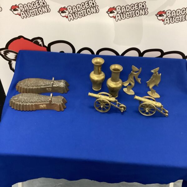 Vintage brass cannons displayed as a collectable lot.