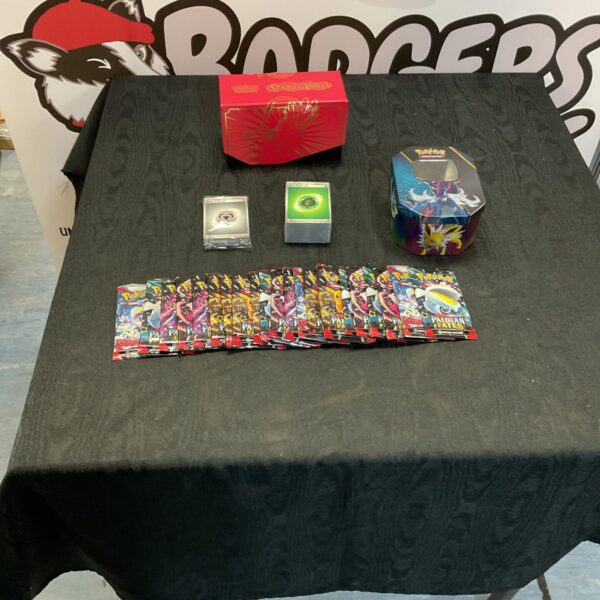 Pokemon card collection with opened booster packs and tin.