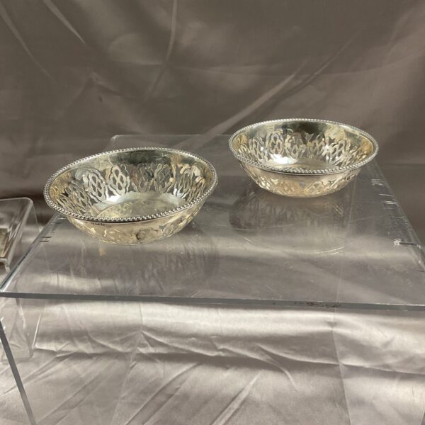 Pair of antique hallmarked silver dishes with pierced detailing.