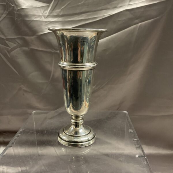 Hallmarked sterling silver trumpet vase on a reflective surface.