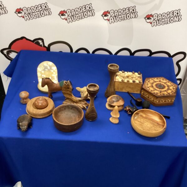 Close-up of a lot of hand-carved wooden mushrooms on a blue background.