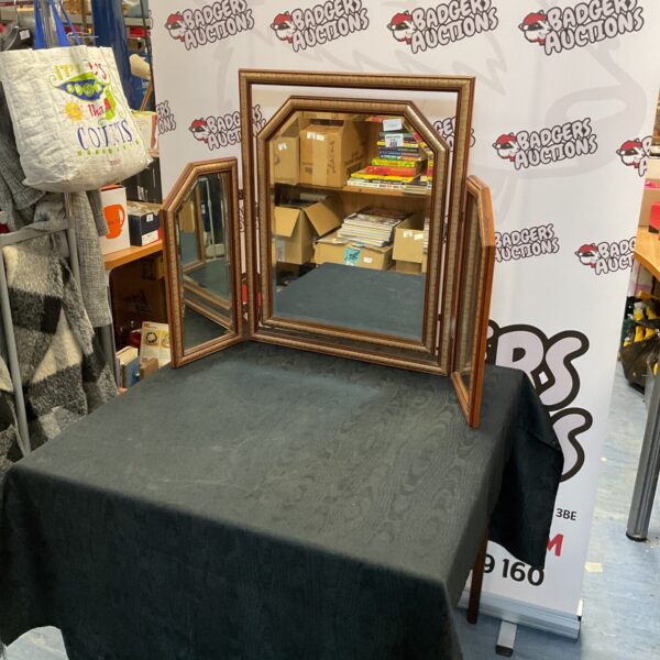 Ornate vintage folding tri-mirror with wooden frame.