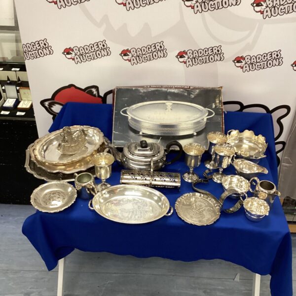 Vintage silverplate goblets and serving dish collection on display.