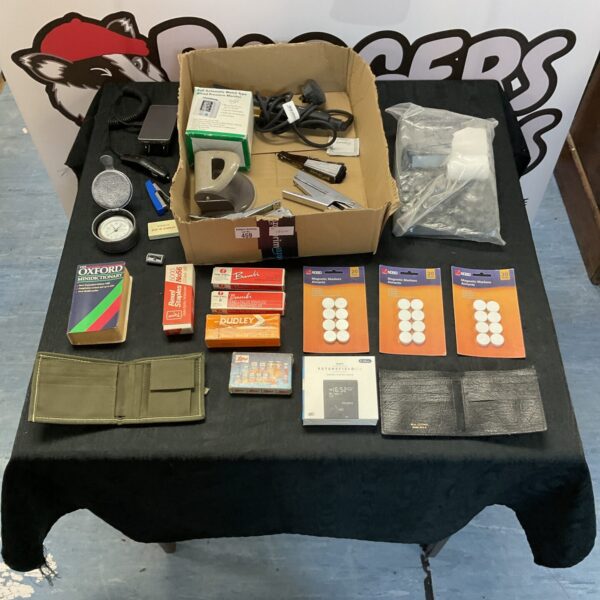 Mixed office supplies lot including wallets and stationery items.