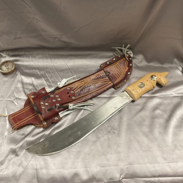 Dominican Republic machete with leather sheath, vintage agricultural tool.