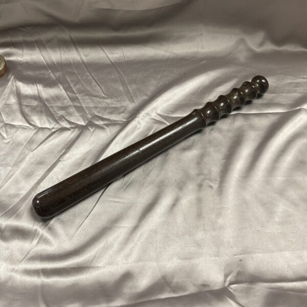 Vintage wooden police truncheon, a classic law enforcement tool.