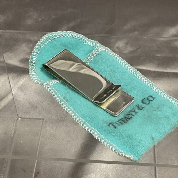 Tiffany & Co money clip displayed on a blue polishing cloth.
