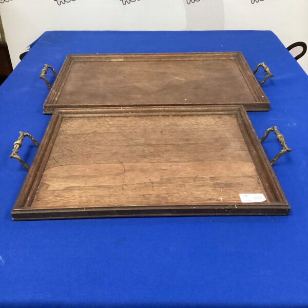 Vintage wooden serving trays with brass handles, rustic home decor.