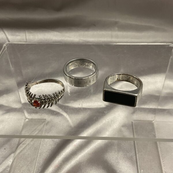 Lot of three large men’s rings in silver tone.