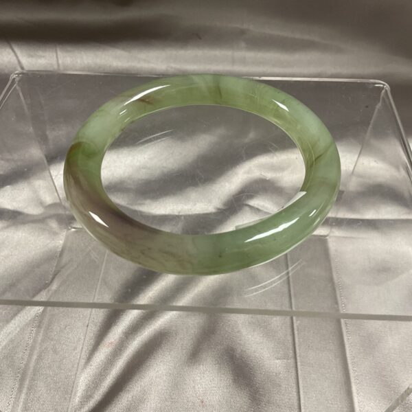 Large green jade bangle, a beautiful piece of Asian jewellery.