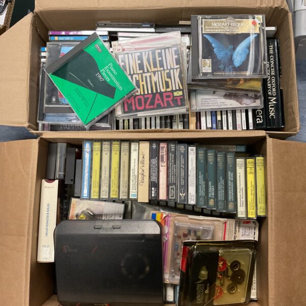 Lot of classical music CDs and cassette tapes, including Mozart recordings.