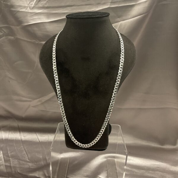 Close-up of a silver curb chain necklace on a display.