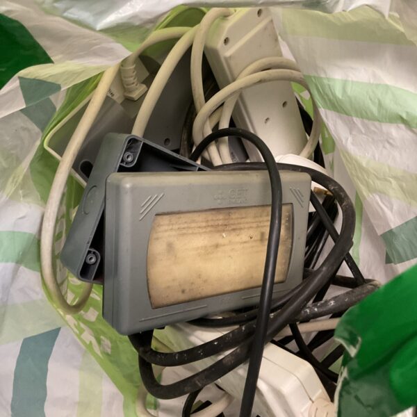 Collection of used plug socket extensions for increasing electrical outlets.