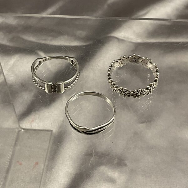 Close-up of a delicate floral silver ring.