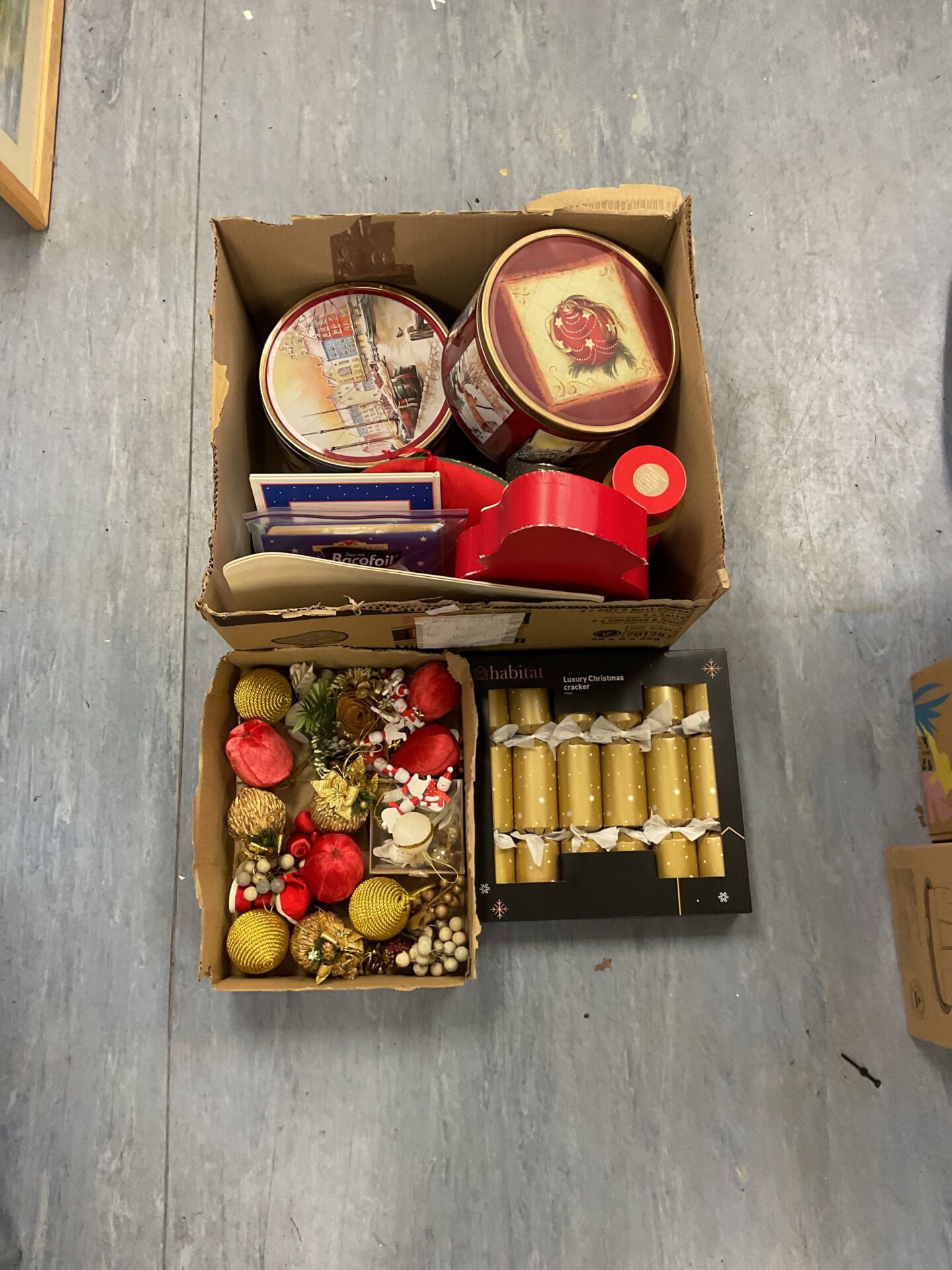 493 Two boxes of mixed Christmas decorations inc baubles, new crackers and selection of tins