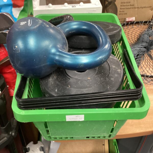 Lot of dumbbell and kettlebell weights for fitness training.