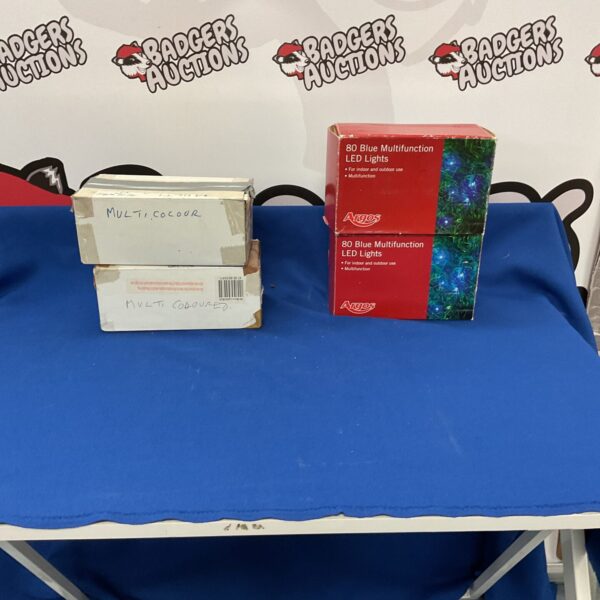 Box of multicoloured string lights and two boxes of blue leg lights.