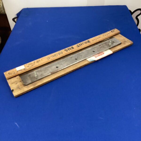 Vintage paper guillotine blade showing signs of wear.