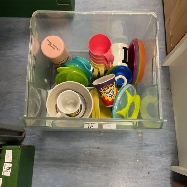 Mixed plastic tableware including a Creme Egg mug.