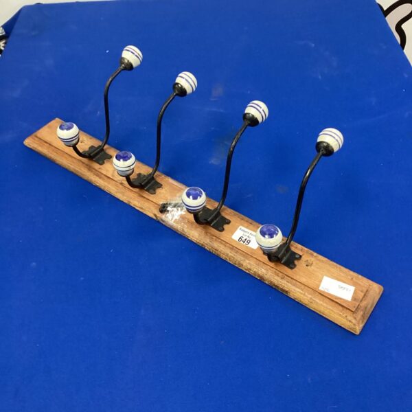 Vintage coat hooks with ceramic knobs and iron base.