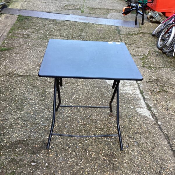 Black folding table, ideal for portable use and storage.
