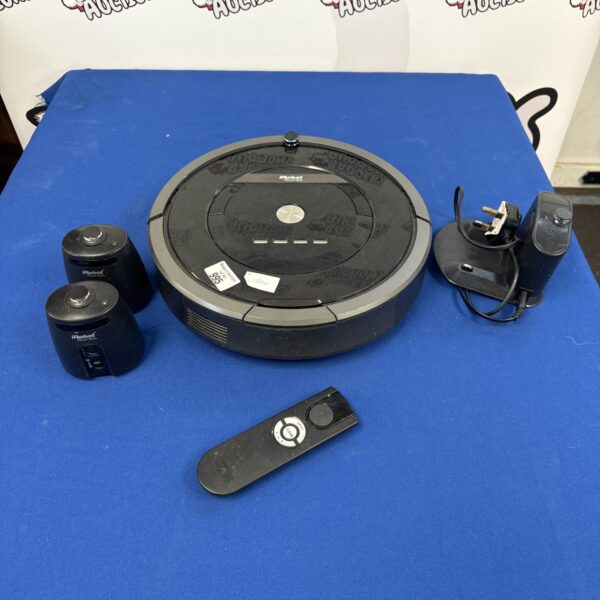 iRobot Roomba vacuum cleaner with charging dock and remote control.