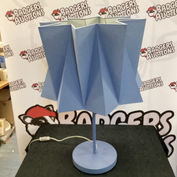 Blue modernist table lamp with circular base and shade.