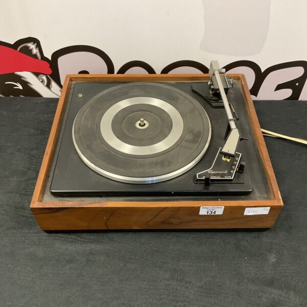 Vintage Garrard record player on a wooden plinth.