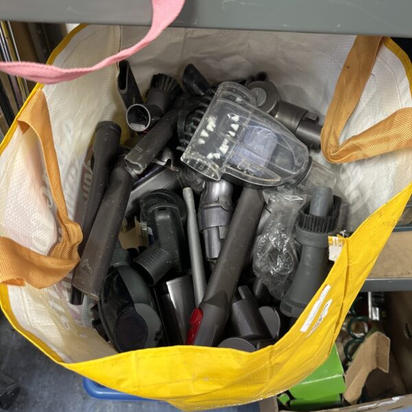 Mixed lot of Dyson cordless hoover accessories for various cleaning tasks.