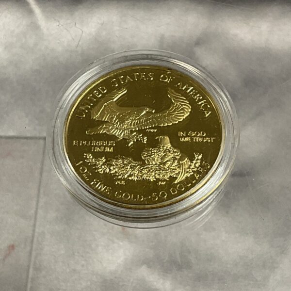 Gold reproduction coin obverse featuring an eagle design.